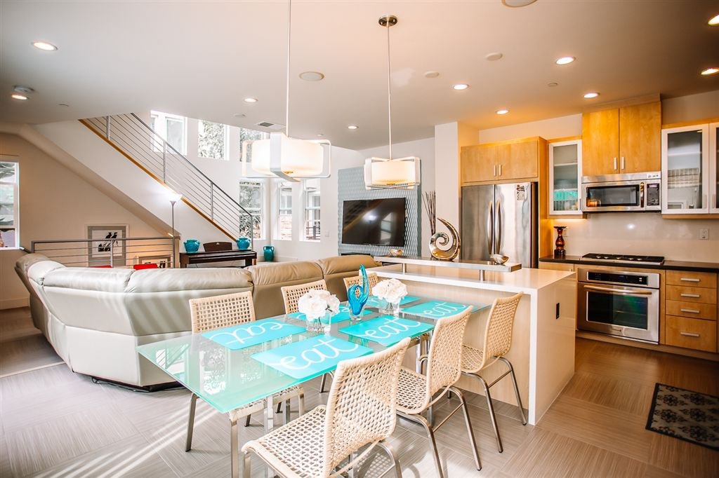 View from exterior patio into living room and dining room. Open Floor Plan concept to the max.